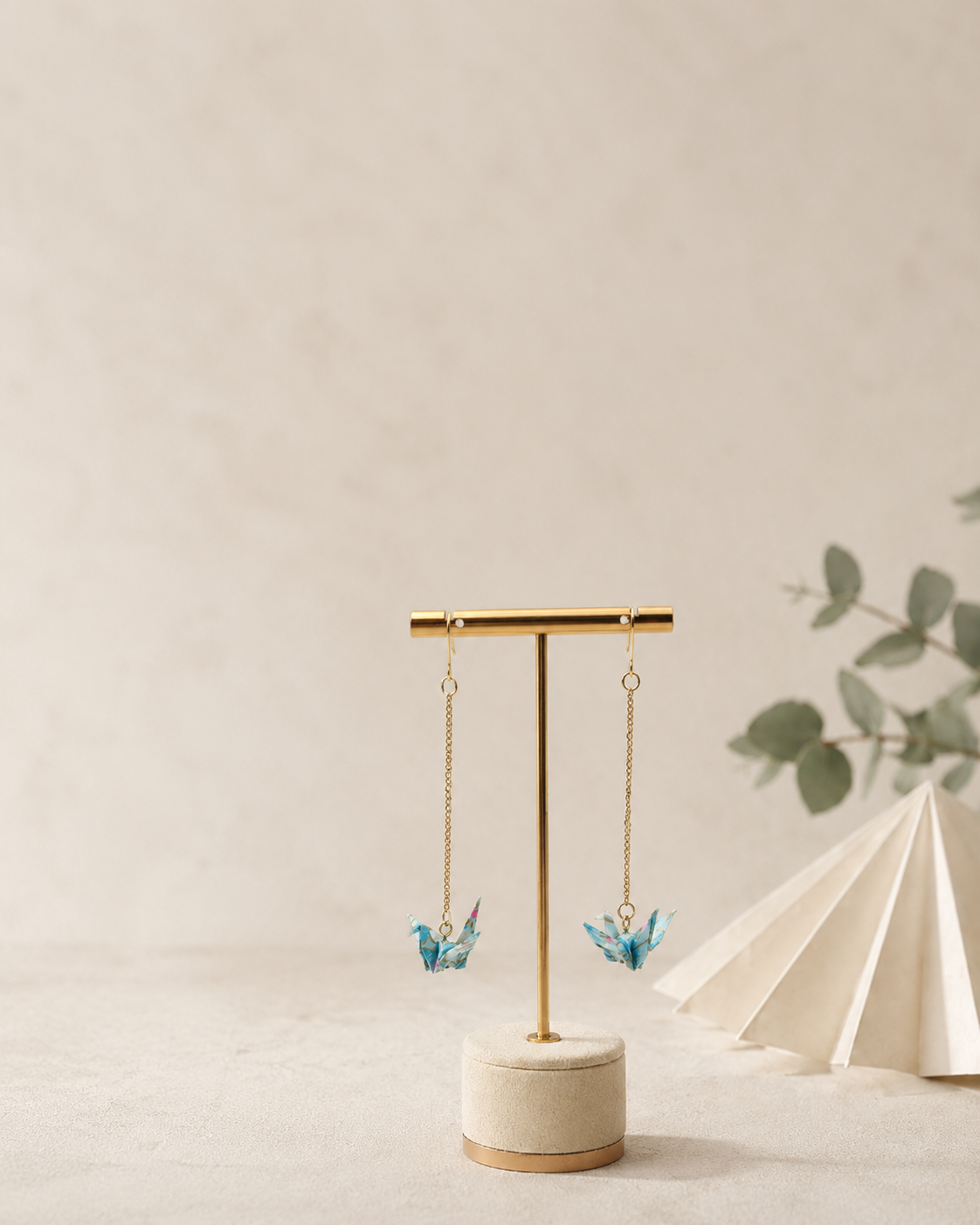 Long origami crane earrings showing their fine chain and lightweight folded-paper design
