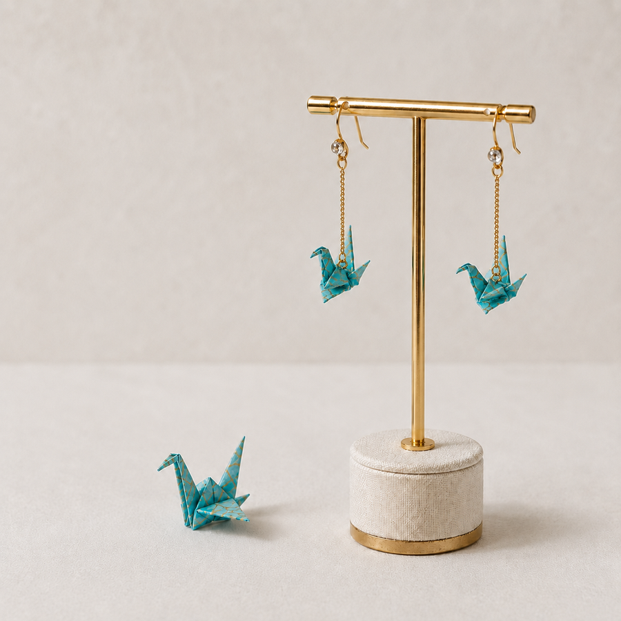 Folded paper origami jewellery protected with resin