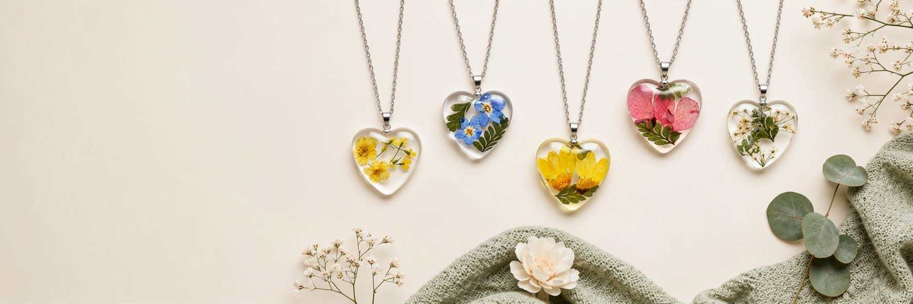 Heart-shaped necklaces containing real flowers representing the months of the year