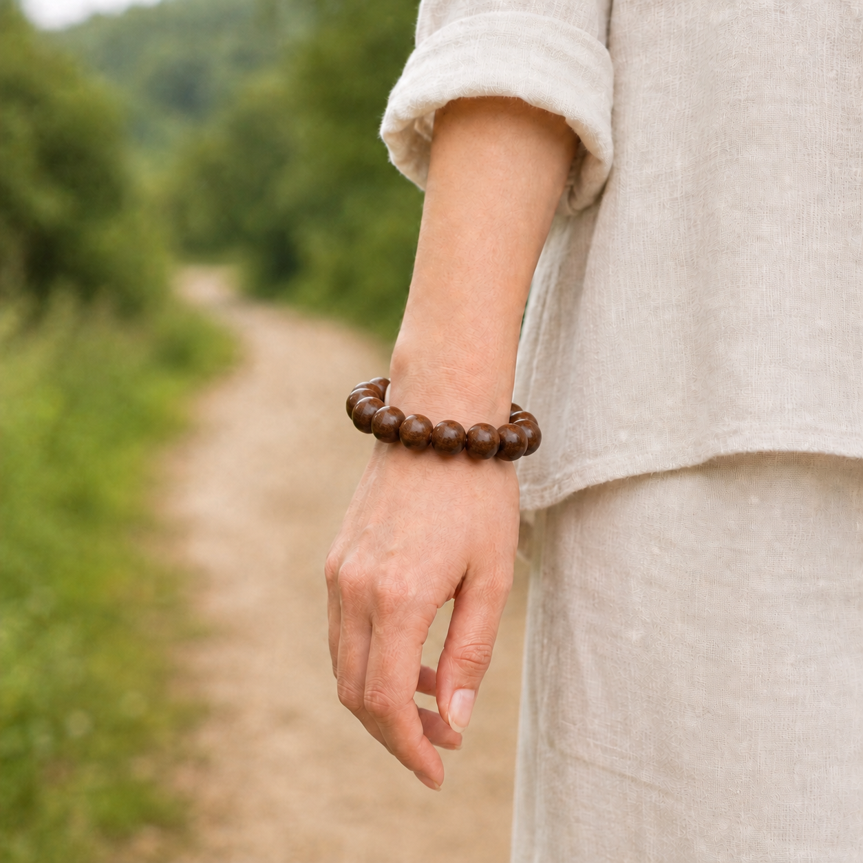 Medium rosewood bead bracelet worn on the wrist outdoors