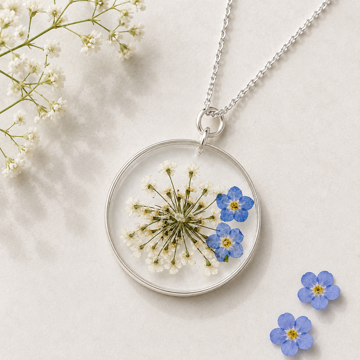 Real forget-me-not flowers preserved inside a clear resin necklace